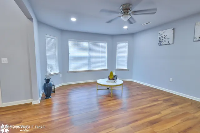 a kitchen with stainless steel appliances granite countertop a lot of counter space and wooden floors