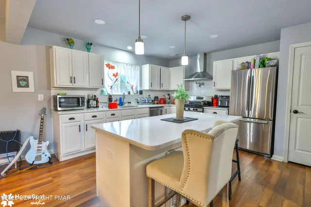 a kitchen with stainless steel appliances a refrigerator sink and cabinets