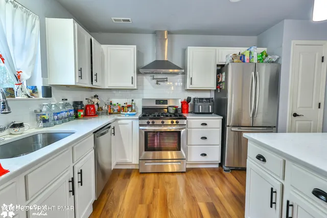 a dining room with furniture a chandelier and wooden floor