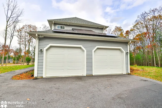 a view of a house with a yard and garage