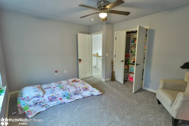 a bedroom with a bed and a table in it