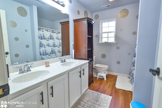 a bedroom with a bed and a lamp on the dresser