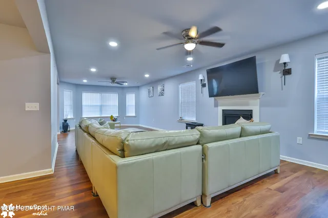 a living room with furniture a flat screen tv and a fireplace