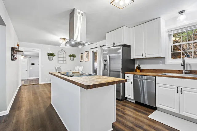a kitchen with stainless steel appliances granite countertop a sink and a stove