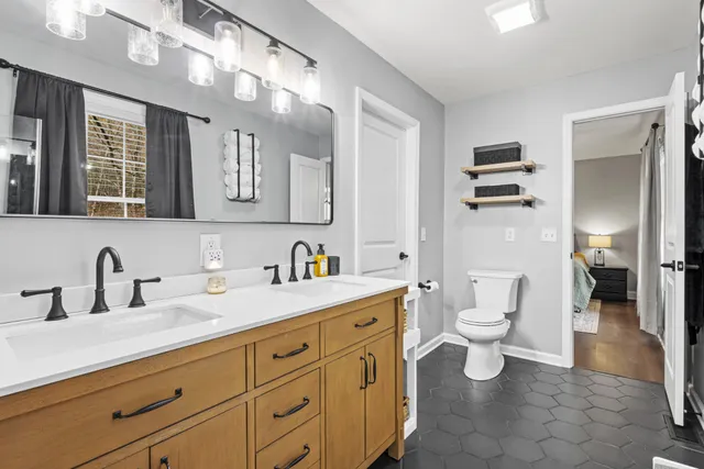 a bathroom with a toilet sink and mirror