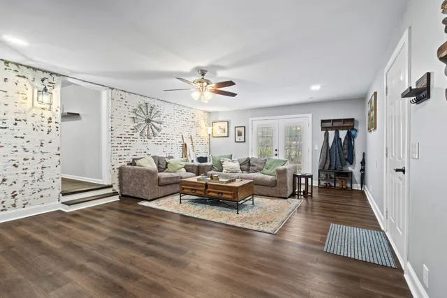 a living room with furniture and wooden floor