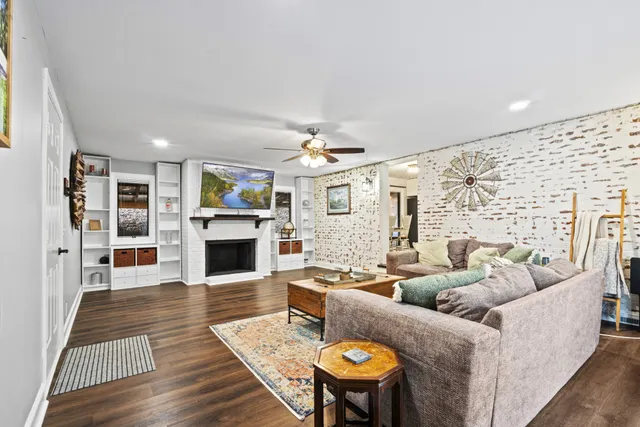 a living room with fireplace furniture and a wooden floor