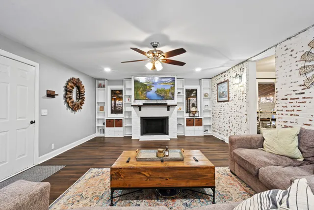 a living room with furniture a fireplace and a flat screen tv