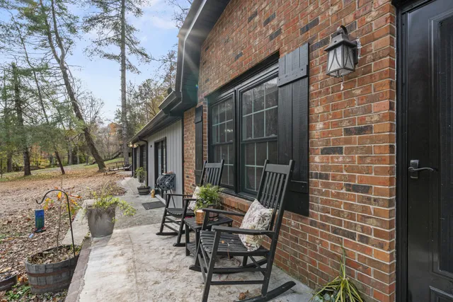 a view of backyard with outdoor seating and barbeque oven