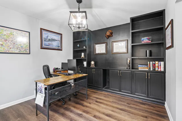 a workspace with furniture and chandelier