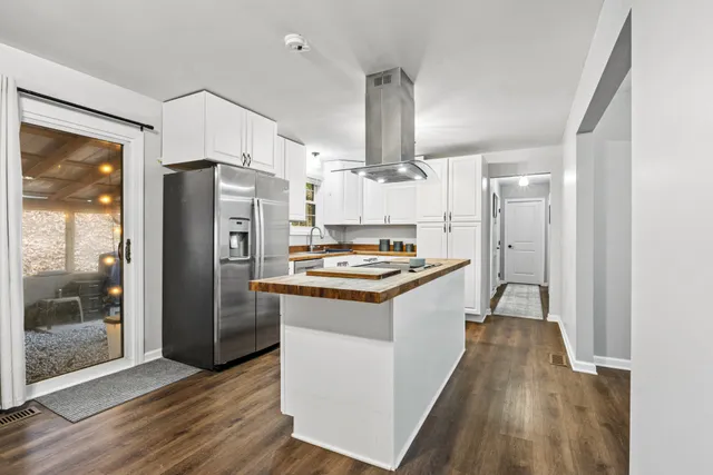 a kitchen with granite countertop a refrigerator and a stove