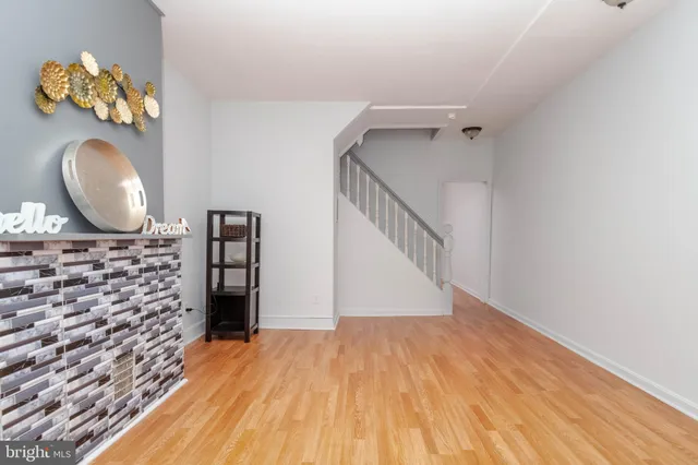a view of a room with wooden floor and staircase