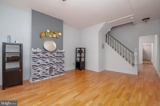 a view of an empty room and wooden floor