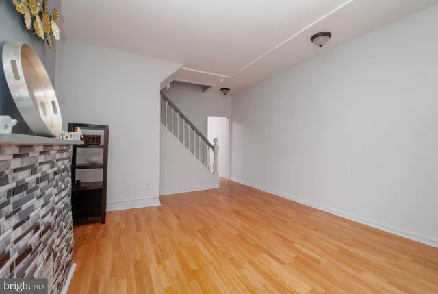 a view of a livingroom with wooden floor and staircase