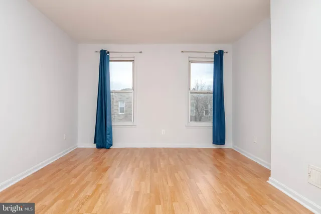 a view of a room with wooden floor and window