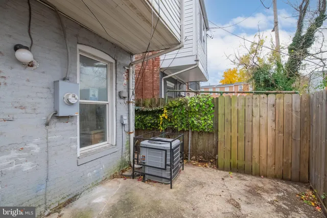 a wooden bench sitting in front of a building