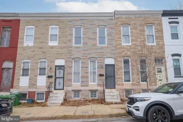 a front view of a house with a parking space