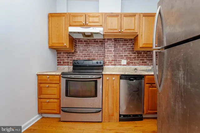 a kitchen with stainless steel appliances granite countertop a stove and a microwave