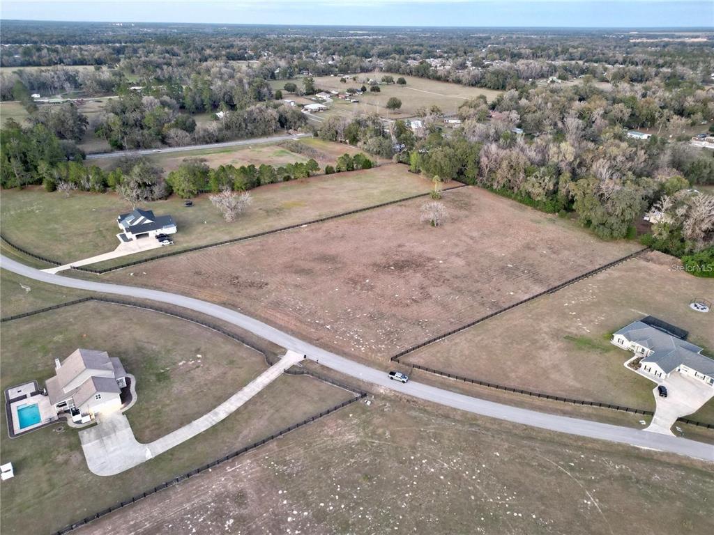 Tbd Southeast 37th Terrace Belleview, FL 34420 - Photo 5 of 11 an aerial view of a house with a yard and lake view