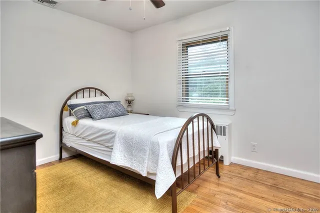 a bedroom with a bed and a window