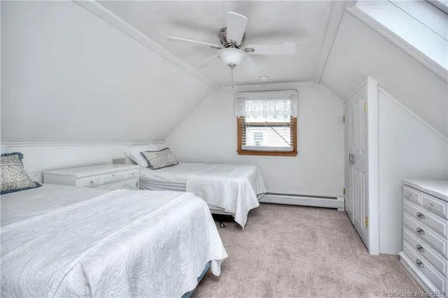 a bedroom with two beds and a dresser