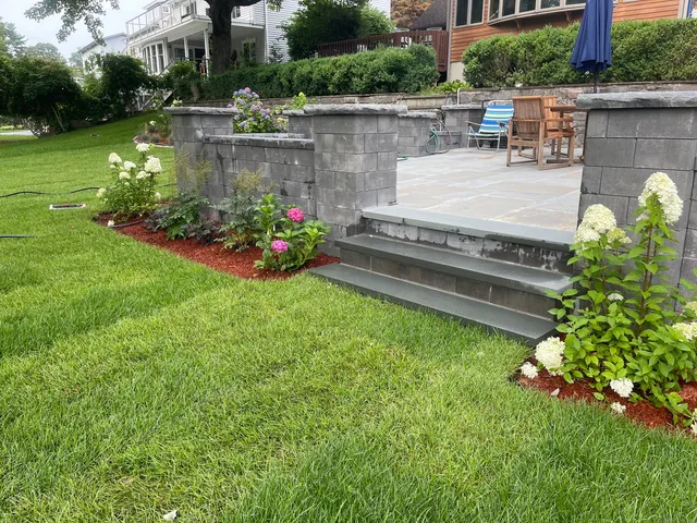 a view of a garden with plants and a fountain
