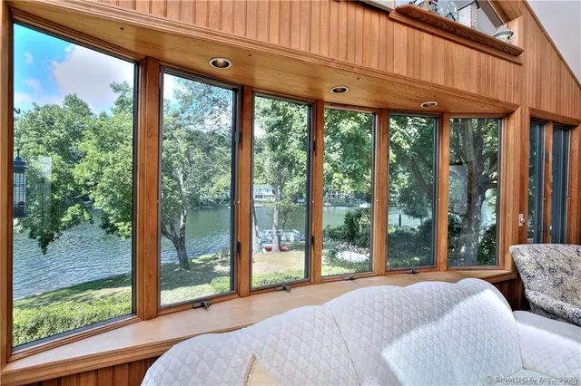 a bedroom with a large window and a bed