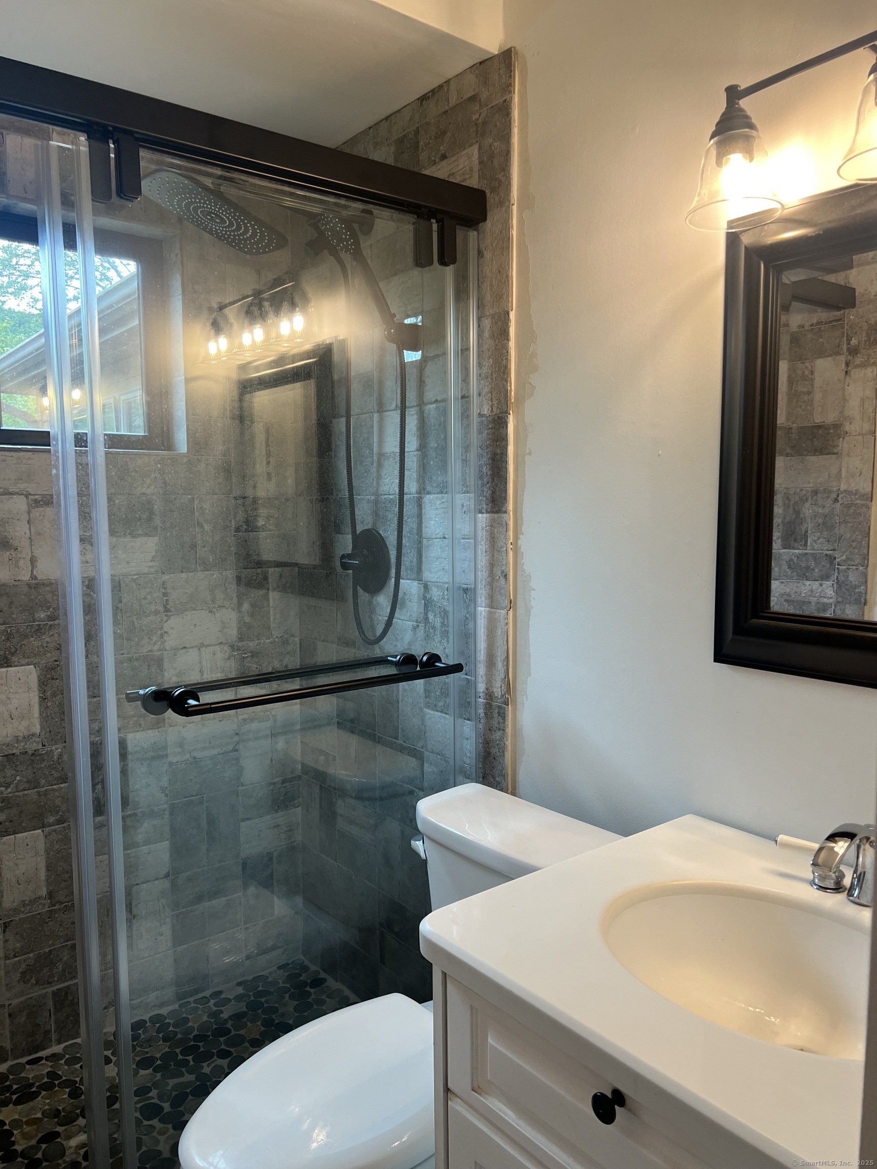 151 Sasapequan Road Fairfield, CT 06824 - Photo 10 of 25 a bathroom with a sink and mirror