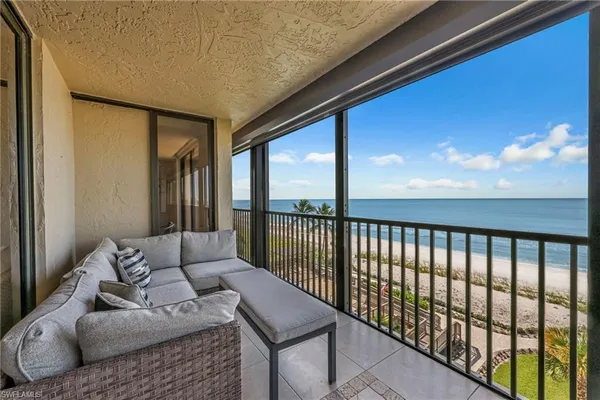 a view of a balcony with furniture and wooden floor