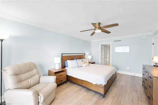 a bedroom with a bed and a painting on the wall
