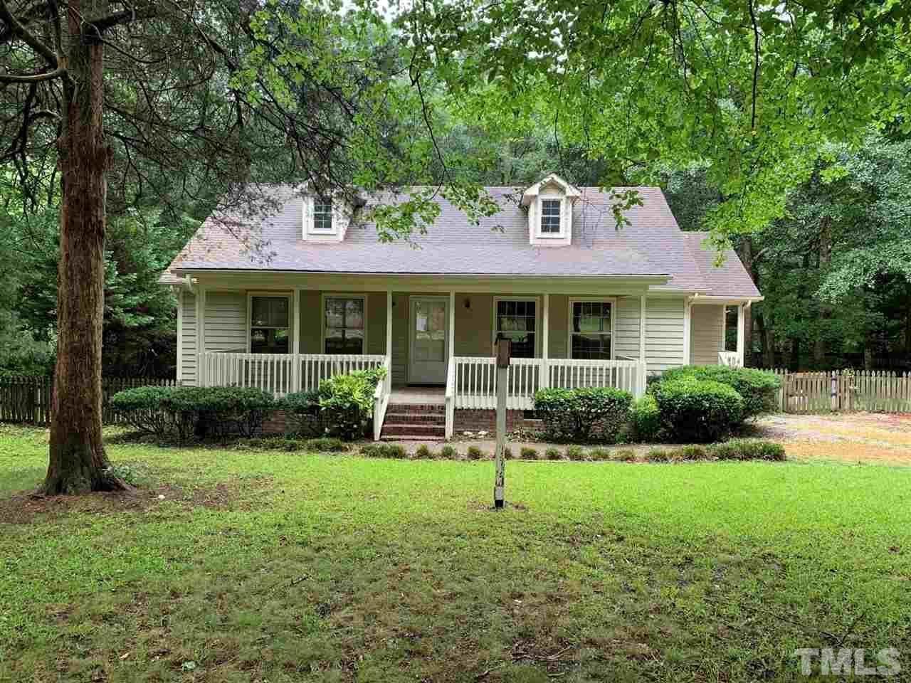 5106 Tomahawk Trail Raleigh, NC 27610 - Photo 3 of 3 a front view of a house with a yard and green space