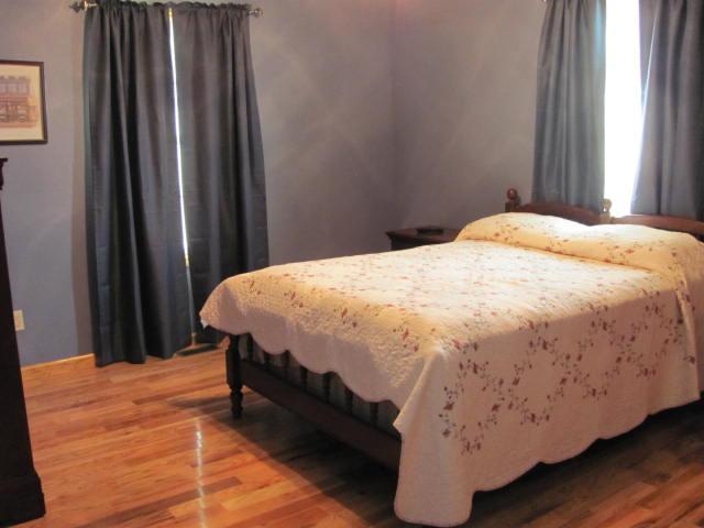 447 R D Prince Road Decherd, TN 37324 - Photo 8 of 20 a bed sitting in a bedroom next to a window