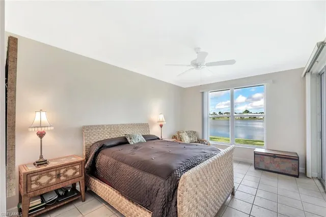 a bedroom with a bed and a lamp with window