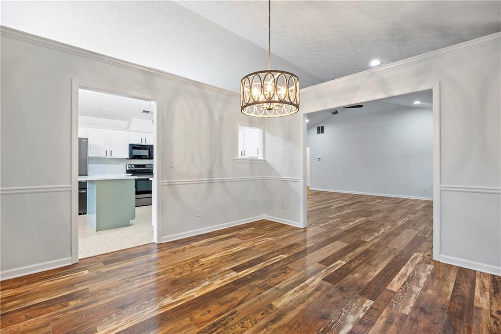 3768 North Sharon Church Road Loganville, GA 30052 - Photo 11 of 58 an empty room with wooden floor and window