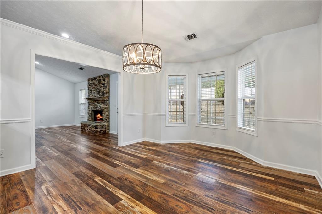 3768 North Sharon Church Road Loganville, GA 30052 - Photo 12 of 58 a view of a livingroom with a furniture wooden floor and chandelier