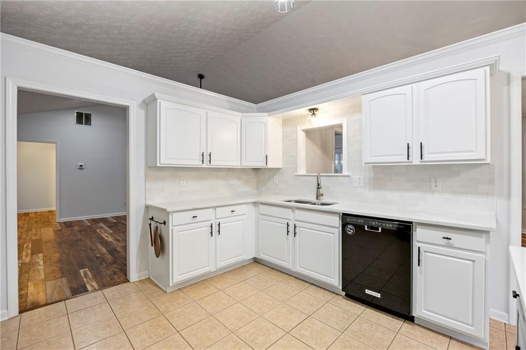 3768 North Sharon Church Road Loganville, GA 30052 - Photo 20 of 58 a kitchen with white cabinets