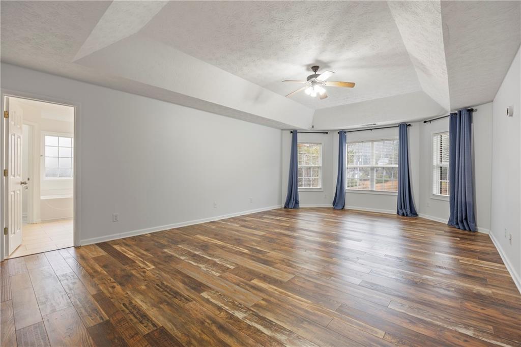 3768 North Sharon Church Road Loganville, GA 30052 - Photo 22 of 58 a view of an empty room with window and wooden floor