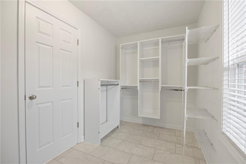3768 North Sharon Church Road Loganville, GA 30052 - Photo 32 of 58 a view of an empty room with cabinet and entryway