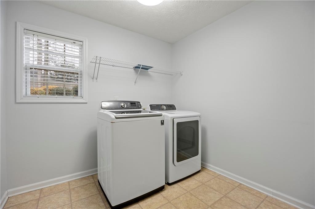 3768 North Sharon Church Road Loganville, GA 30052 - Photo 35 of 58 a utility room with dryer and washer