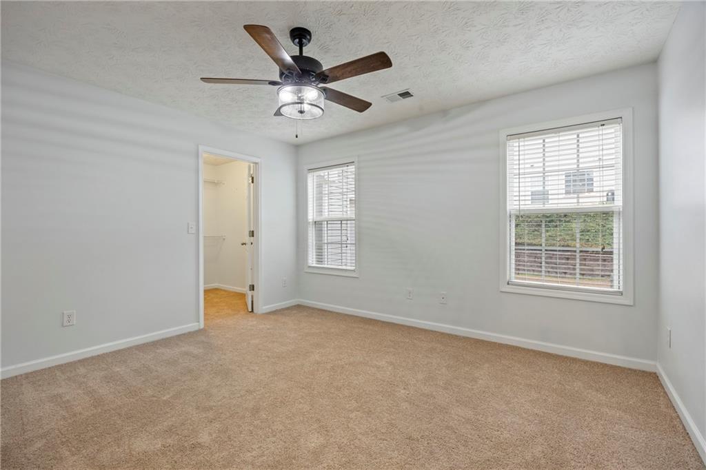 3768 North Sharon Church Road Loganville, GA 30052 - Photo 37 of 58 an empty room with windows and fan
