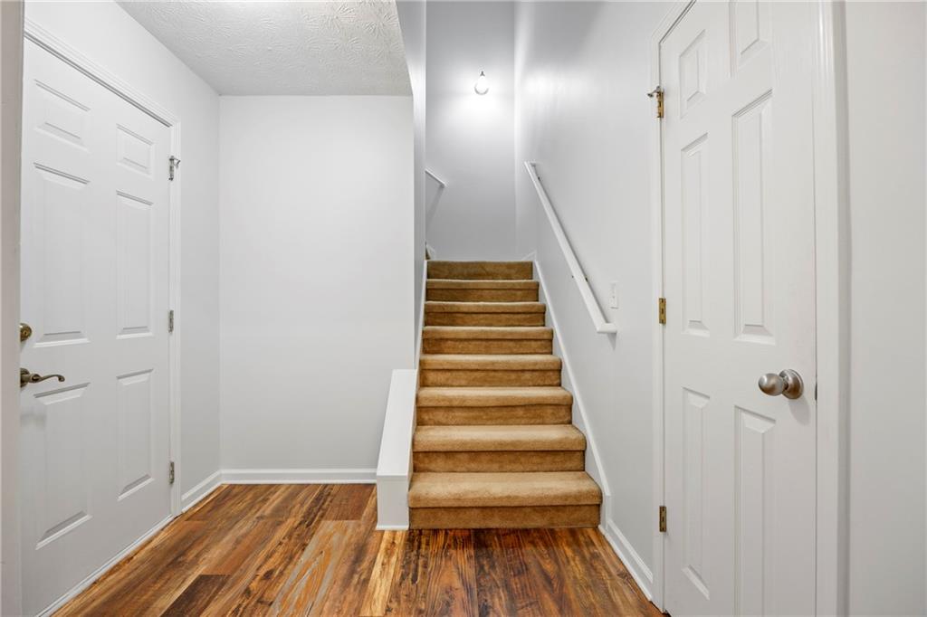 3768 North Sharon Church Road Loganville, GA 30052 - Photo 38 of 58 a view of a hallway with wooden floor and entryway