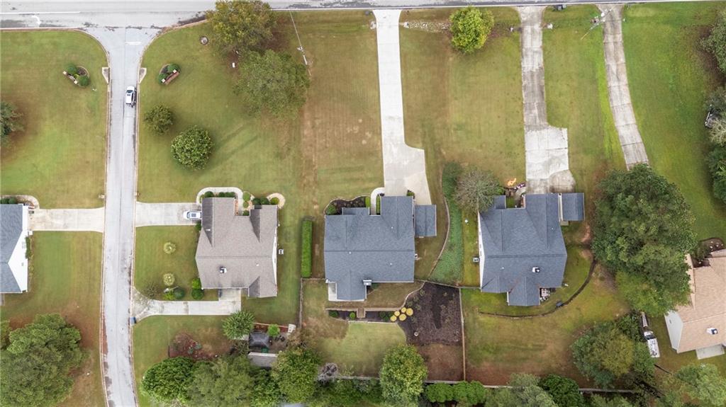 3768 North Sharon Church Road Loganville, GA 30052 - Photo 42 of 58 an aerial view of residential houses with outdoor space