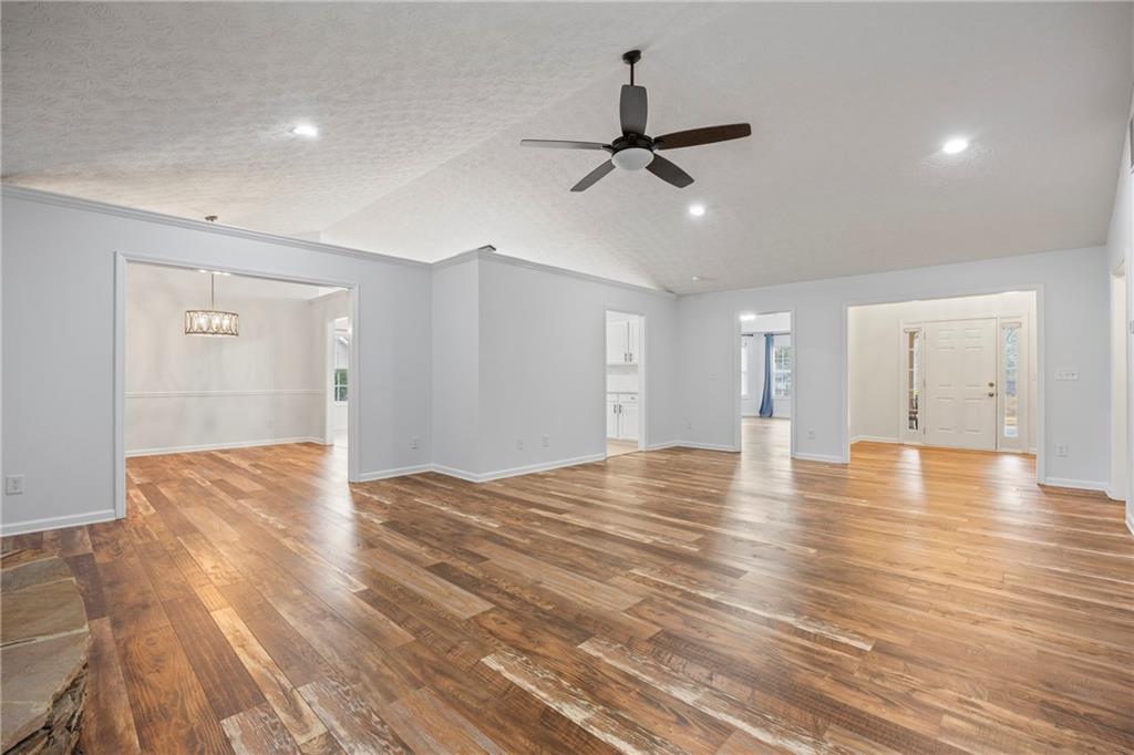 3768 North Sharon Church Road Loganville, GA 30052 - Photo 9 of 58 a view of empty room with wooden floor and ceiling fan