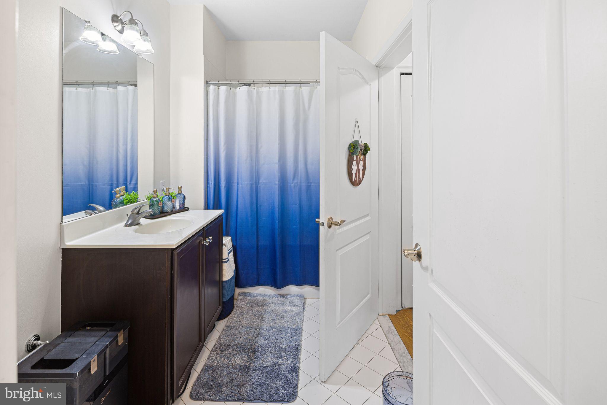 331 Carson Terrace, Unit 331 Huntingdon Valley, PA 19006 - Photo 15 of 15 a bathroom with a tub sink and mirror