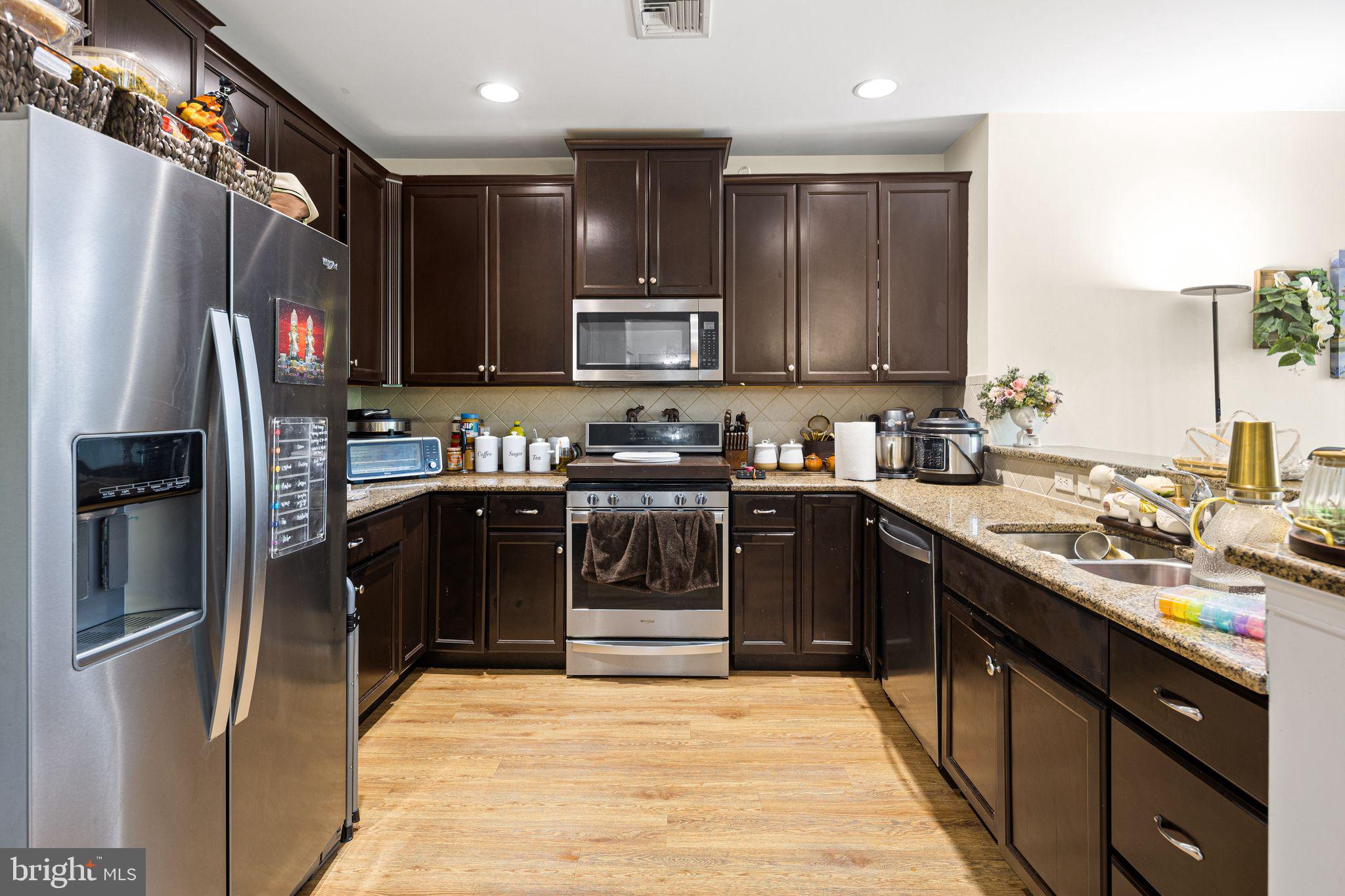 331 Carson Terrace, Unit 331 Huntingdon Valley, PA 19006 - Photo 8 of 15 a kitchen with stainless steel appliances granite countertop a refrigerator and a sink