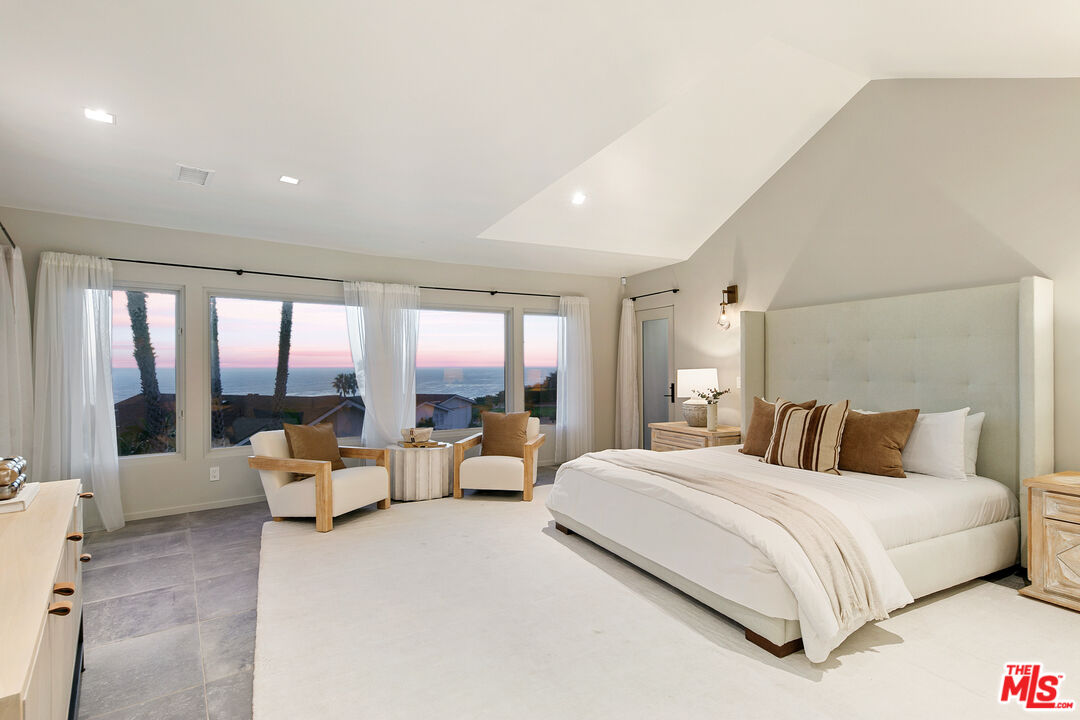 31558 Victoria Point Road Malibu, CA 90265 - Photo 30 of 55 a bedroom with bed and large glass window