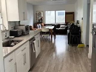 a kitchen with lots of counter top space and wooden floor