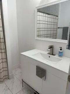 a bathroom with a sink a vanity and a window