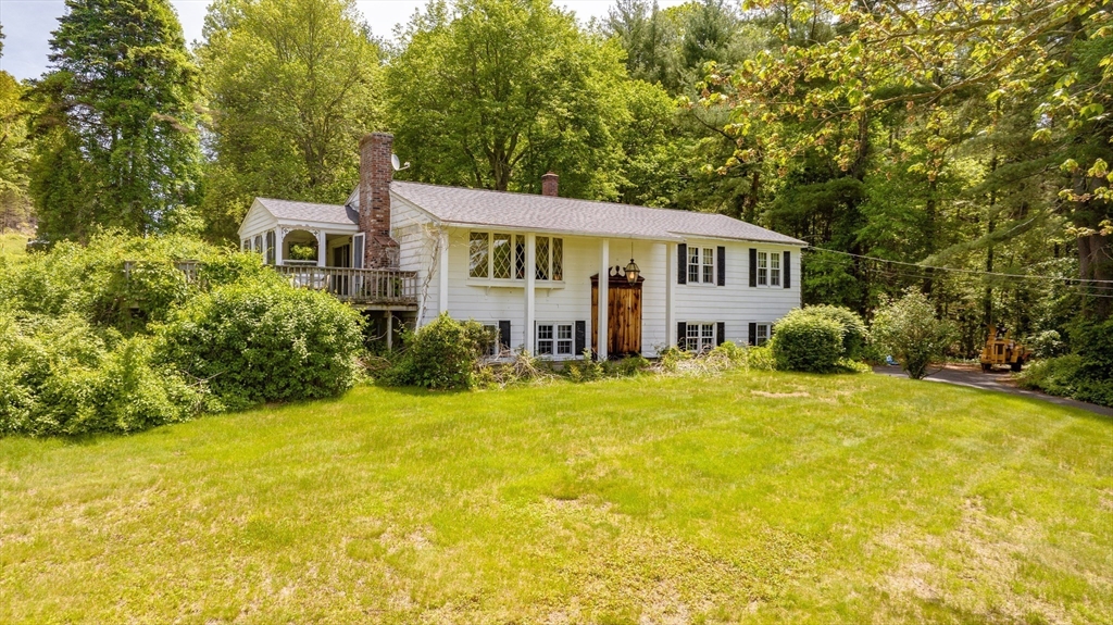 189 Scantic Road Hampden, MA 01036 - Photo 11 of 42 a front view of a house with a yard and trees