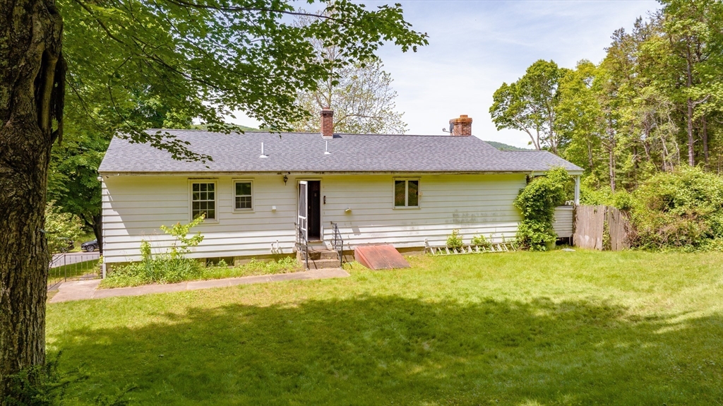 189 Scantic Road Hampden, MA 01036 - Photo 13 of 42 a front view of a house with a yard